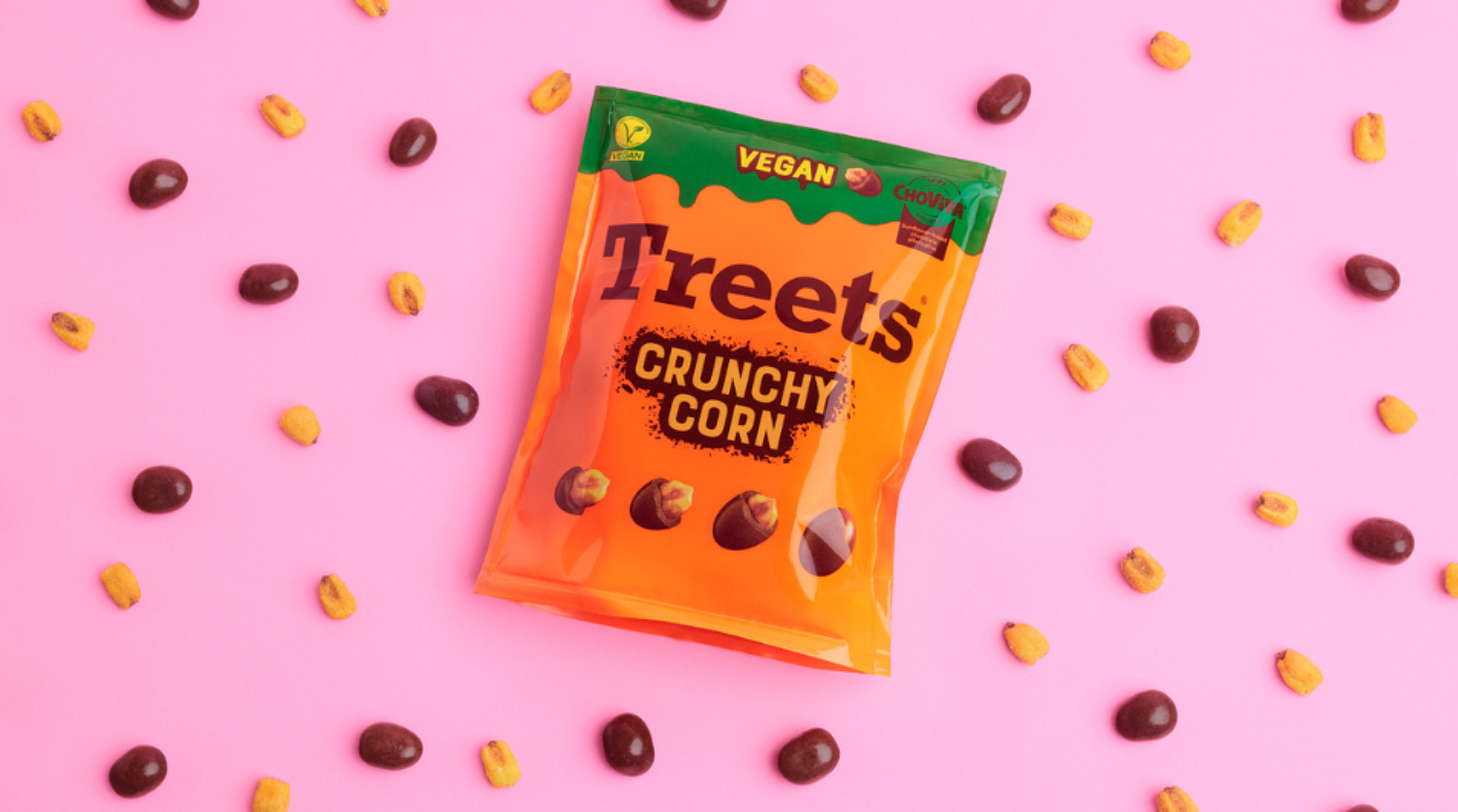 Treets vegan Crunchy corn product placed among corn and chocolate