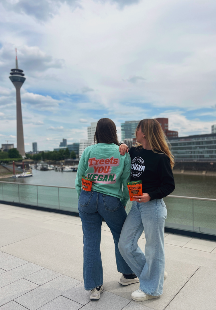 Two people looking into the city with Treets ChoViva in their hand